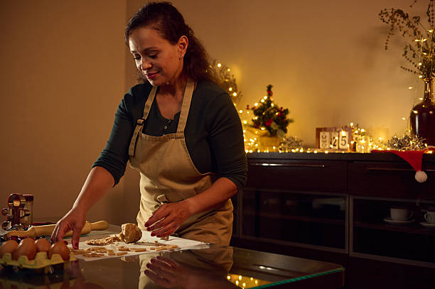 istock Woman Preparing Gingerbread Cookies in a Festive Christmas Kitchen Setup 2235410131