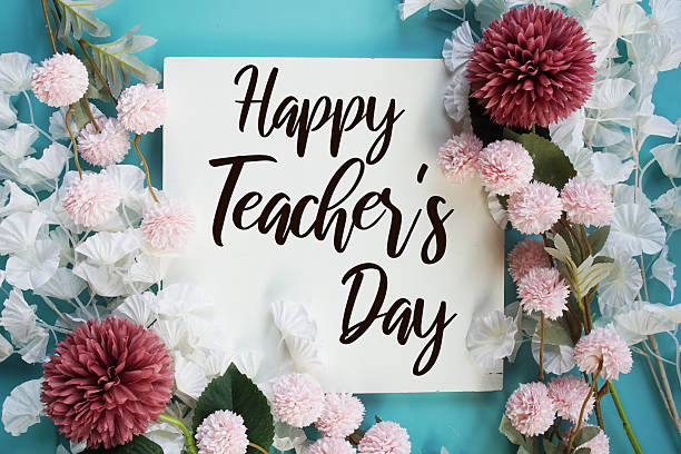 istock Happy Teacher's Day text with flowers frame decoration top view on blue background 2235411652