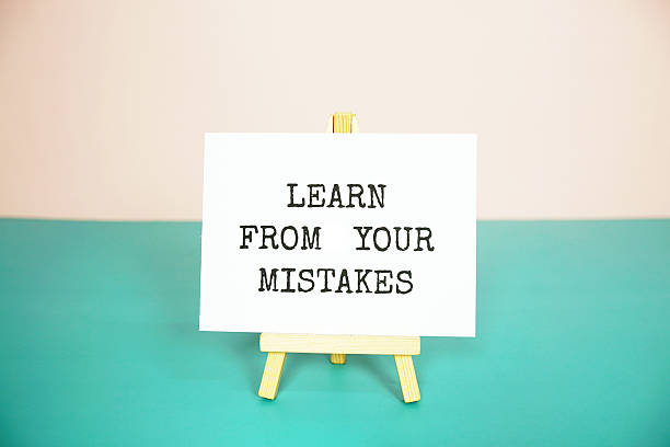 istock Learn from your mistakes text message on paper card with wooden easel 2235411781