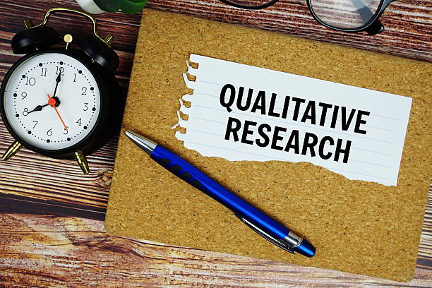istock Qualitative Research text written on paper torn with alarm clock top view 2235411833