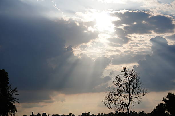 sky with prominent clouds and rays of sunlight piercing through them