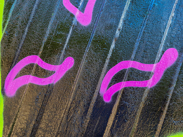 A black painted iron fence with pink stripes.