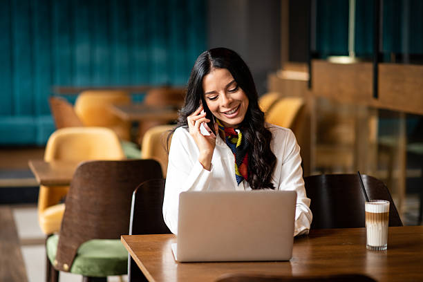 istock Smiling woman talking on smartphone 2235414574