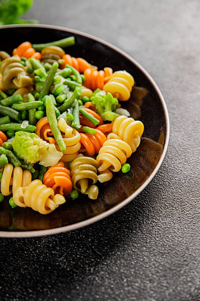 istock Trottole pasta vegetables green peas, green beans, kohlrabi cabbage, broccoli second course tasty snack fresh delicious gourmet food background on the table rustic food top view copy space 2235415918