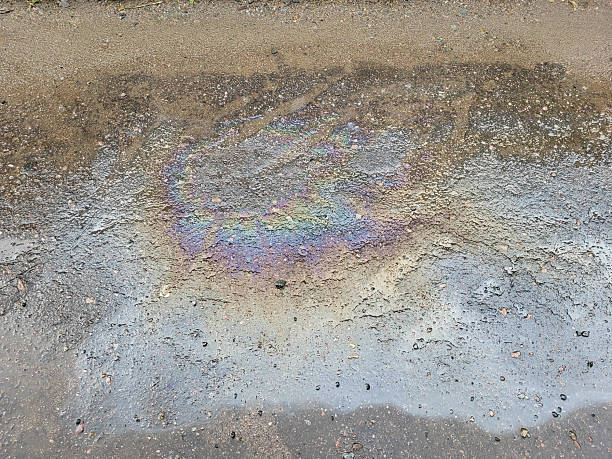 istock A gasoline spill from a car on wet asphalt after rain. 2235417010