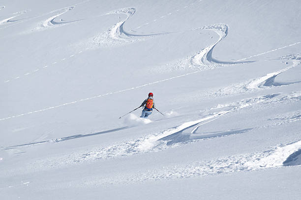 istock Single offpiste skier making fresh tracks in powder snow 2235417202