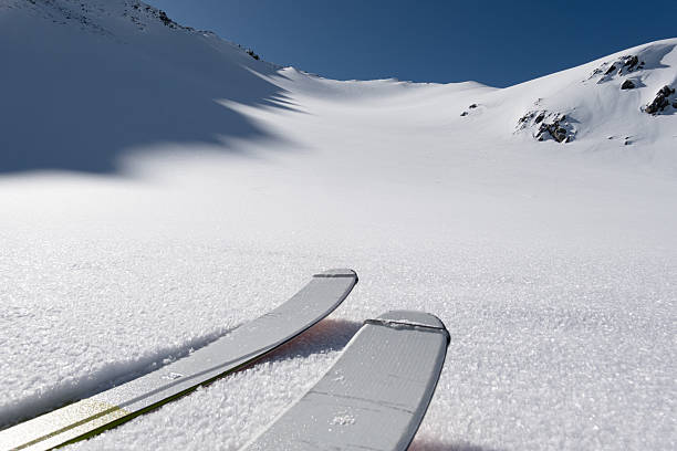snowy alpine panorama with skis on the precipice