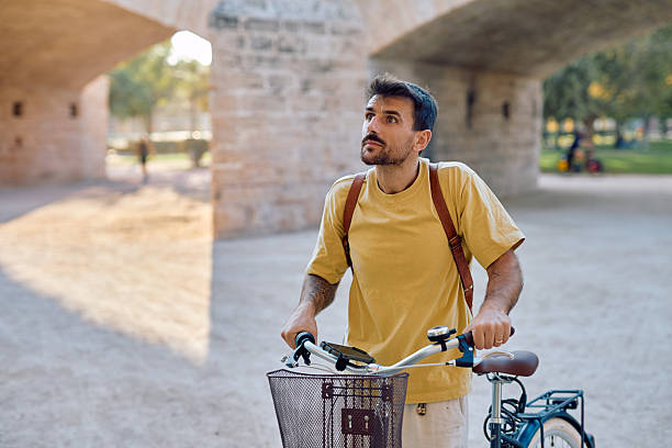 istock Tourist walking with his bicycle under a bridge in Valencia 2235420940