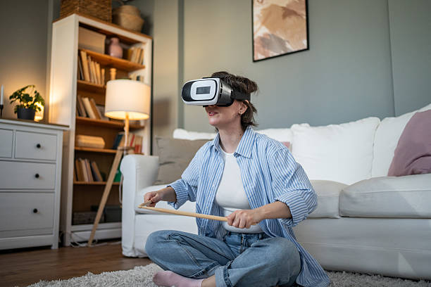 istock Woman playing drums in virtual reality at home 2235425321