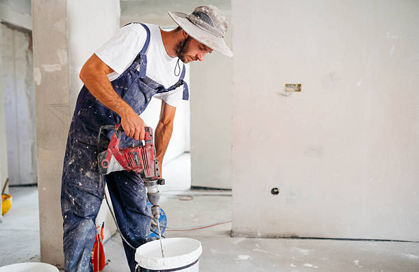 istock Mixing concrete with tile adhesive mixing machine in a bucket 2235436345