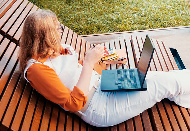 istock Freelancer enjoying freedom while working outdoors on a laptop during a sunny day 2235439887