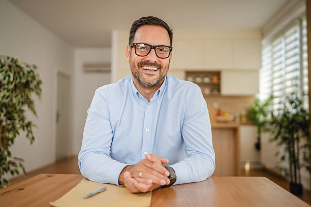 istock Smiling businessman working from home having video call conference meeting 2235440040