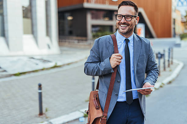 istock Confident Businessman Smiling Outdoors Holding a Tablet in Urban Setting 2235440173