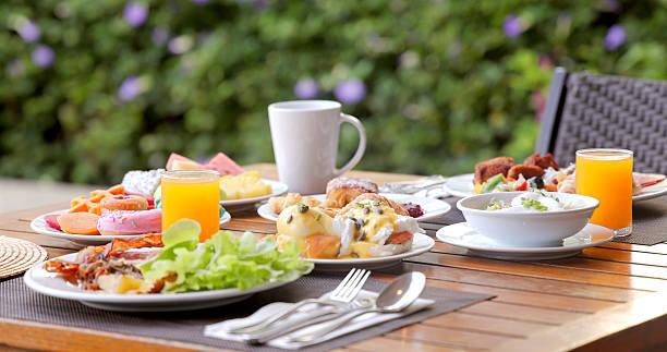 istock Outdoor brunch table with fresh breakfast dishes, juice, coffee set on 2235440474