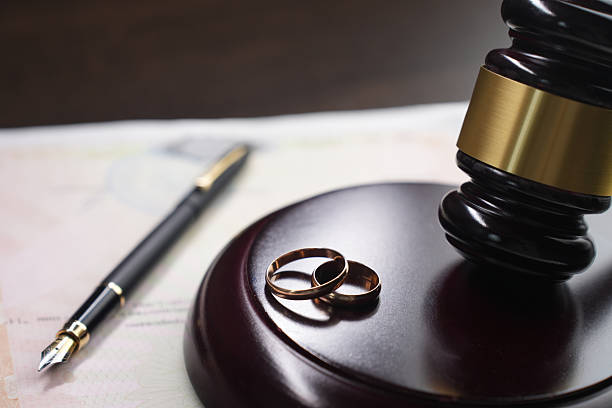 istock Wedding rings and a gavel on legal documents 2235440548