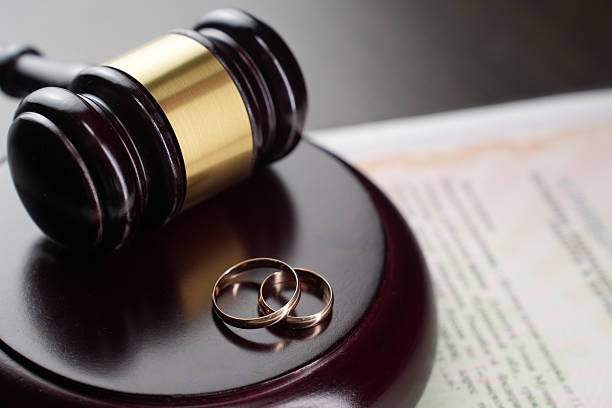 istock Wedding rings and a gavel on legal documents 2235440549