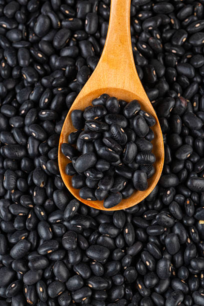 istock Dried black bean on the white background 2235441738