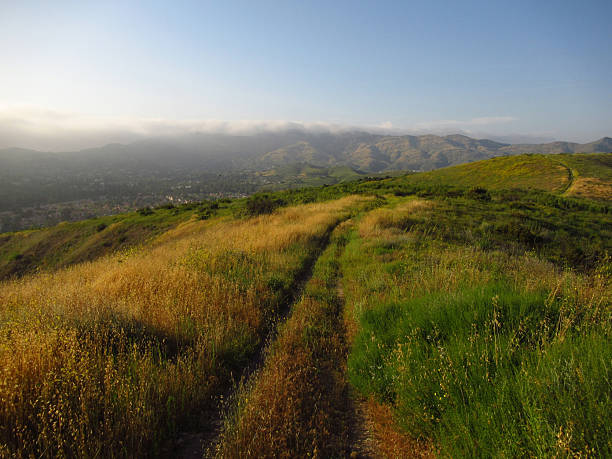 istock Hiking Trail on Hills at Sunset 2235442109
