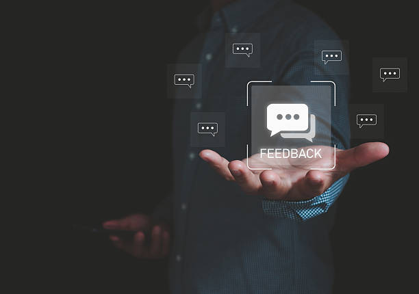 istock Businessman hand holding digital feedback icon with chat message bubbles, customer service review concept, communication and online survey for business improvement and client satisfaction strategy. 2235443850
