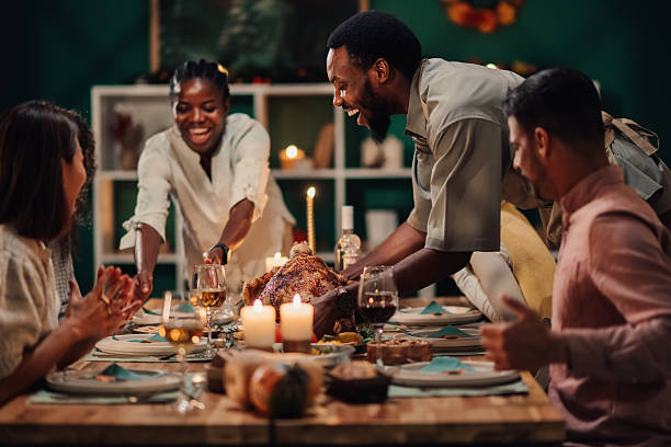 istock Friends serving thanksgiving turkey at home dinner party 2235444178