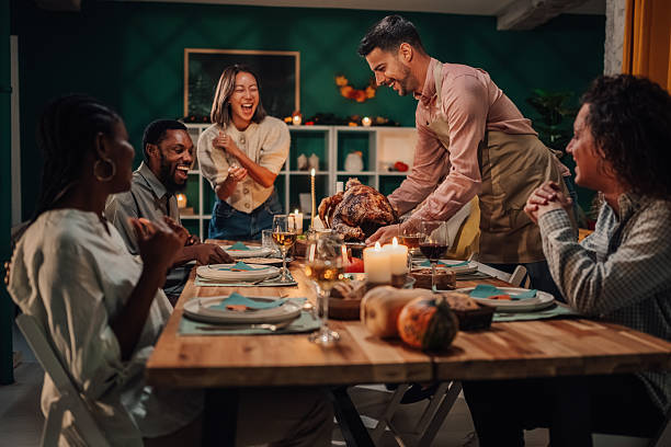 istock Friends enjoying thanksgiving dinner with roasted turkey 2235444180