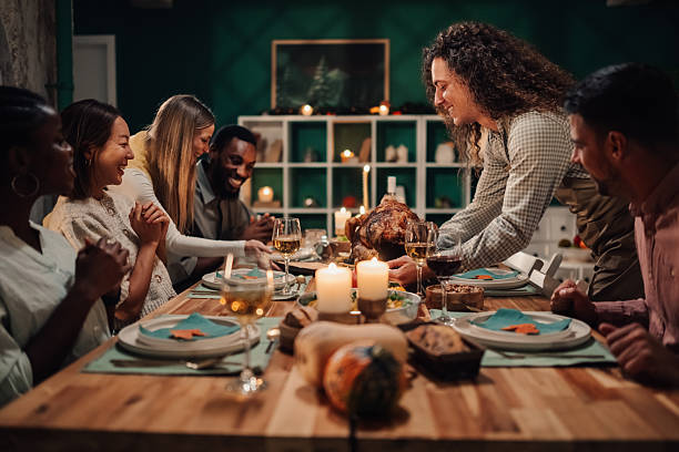 istock Friends enjoying thanksgiving dinner together at home 2235444187