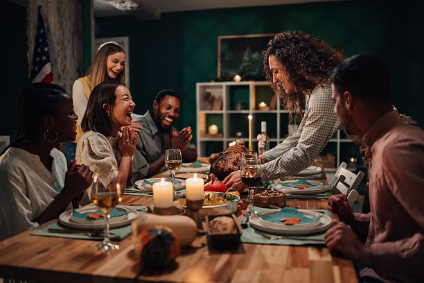 istock Friends giving thanks while enjoying thanksgiving dinner together 2235444193