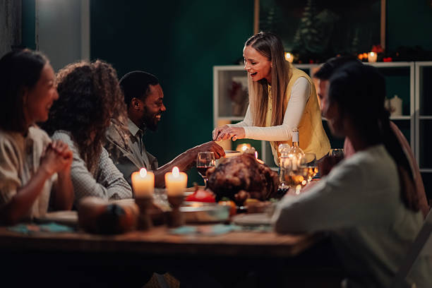 istock Friends enjoying thanksgiving dinner together at home 2235444245