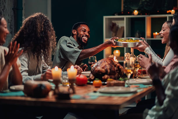 istock Friends sharing food at thanksgiving dinner table 2235444273