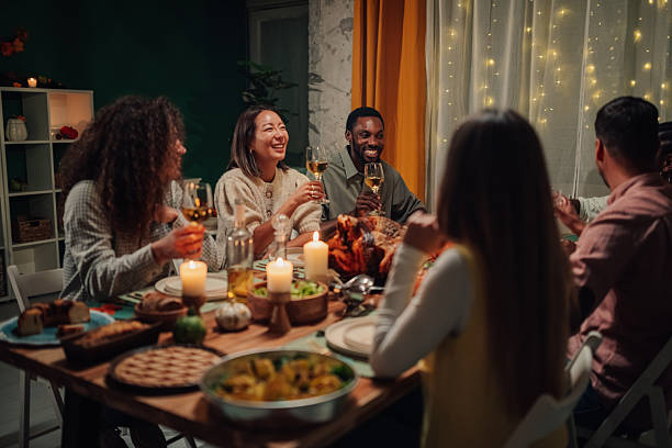istock Friends enjoying thanksgiving dinner together at home 2235444280