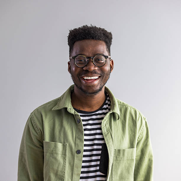 istock Cheerful Man Smiling While Wearing Glasses and a Green Jacket 2235444853