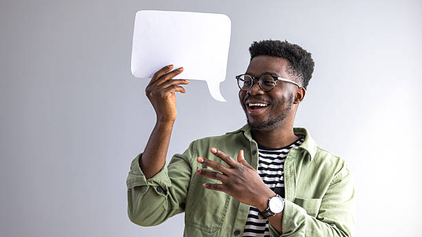 istock Excited Man Holding Blank Speech Bubble for Conceptual Communication Idea 2235444882