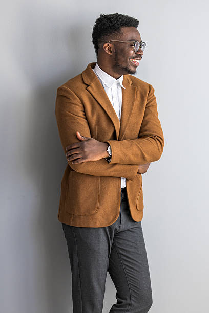 istock Confident Professional Smiling in Stylish Brown Suit With Folded Arms 2235445420