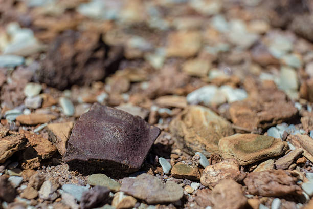 A dark red rock juts out from the gravel floor of the La Candelaria Desert in the eastern Andean mountains of central Colombia, near the village of Raquira.
