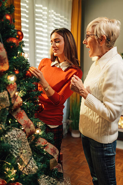 istock Women decorating christmas tree at home 2235446123