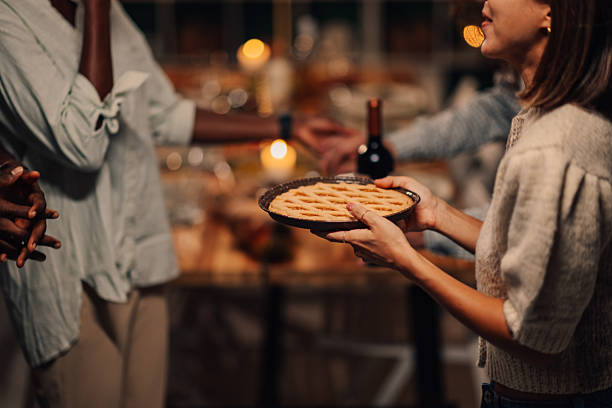 Women in vintage clothes holding apple pie
