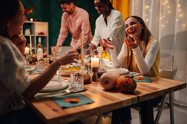 istock Friends enjoying thanksgiving dinner together at home 2235447371
