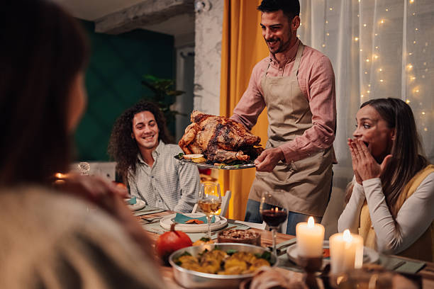istock Family enjoying thanksgiving dinner with roasted turkey 2235447382