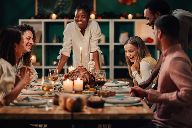 istock Friends enjoying thanksgiving dinner together at home 2235447402