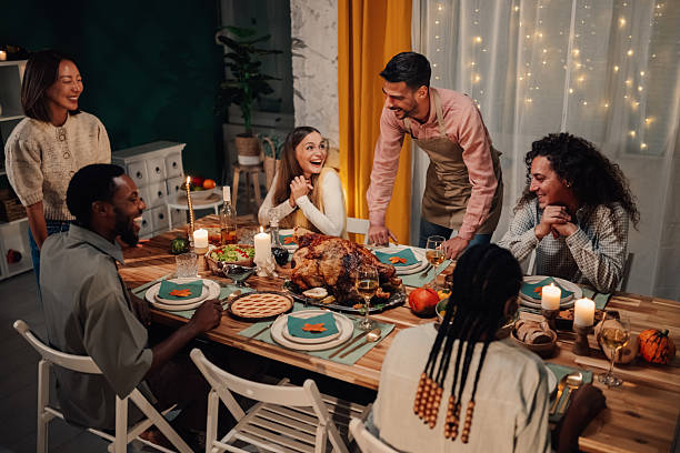 istock Friends enjoying thanksgiving dinner together at home 2235447408