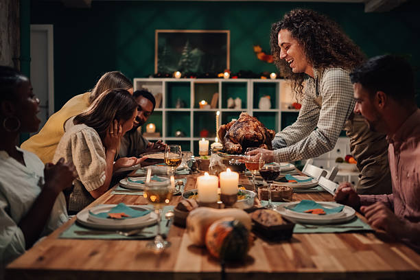 istock Friends celebrating thanksgiving enjoying roasted turkey 2235447410