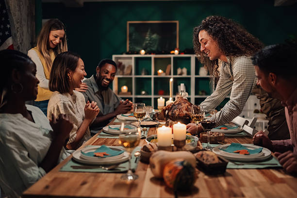istock Friends enjoying thanksgiving dinner together at home 2235447411