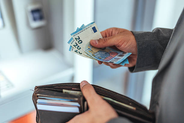 Hands Holding Cash and Wallet at Banking ATM Machine