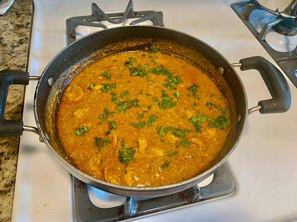 Homemade Indian Chicken Curry Simmering on Stovetop