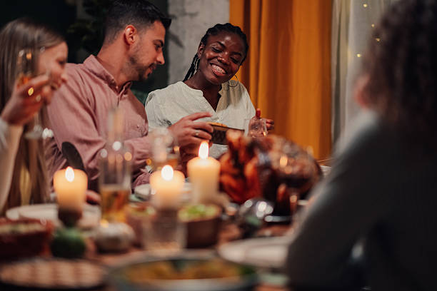 istock Friends enjoying thanksgiving dinner together at home 2235447477