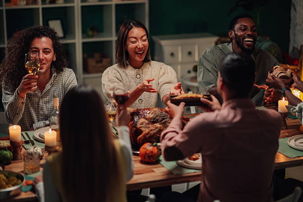 istock Friends enjoying thanksgiving dinner together at home 2235447481