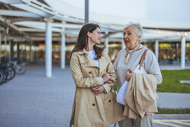 istock Smiling Women Enjoying a Conversation While Shopping Outdoors Together 2235447576