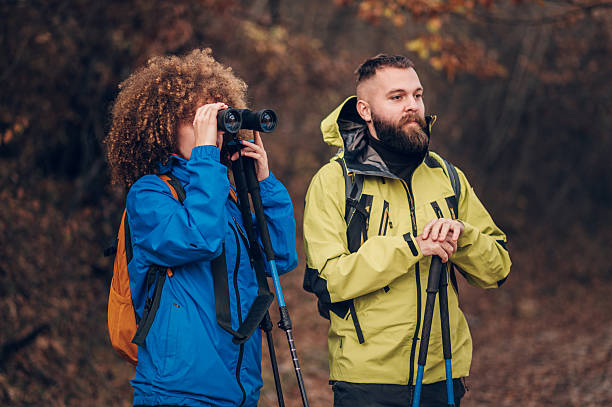istock Hikers observing nature with binoculars in autumn forest 2235448536