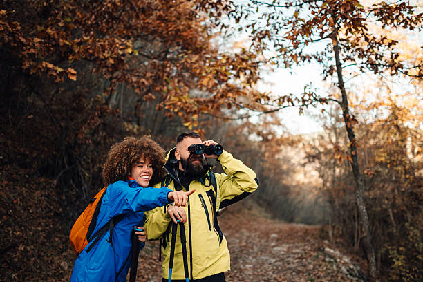 istock Hikers exploring autumn forest with binoculars and trekking poles 2235448664