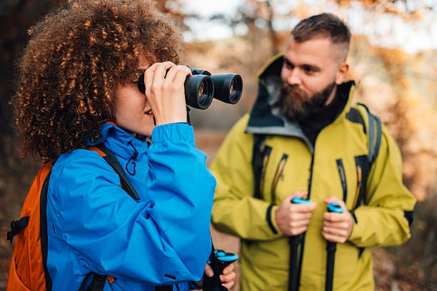 istock Hikers exploring nature and observing wildlife with binoculars 2235448669